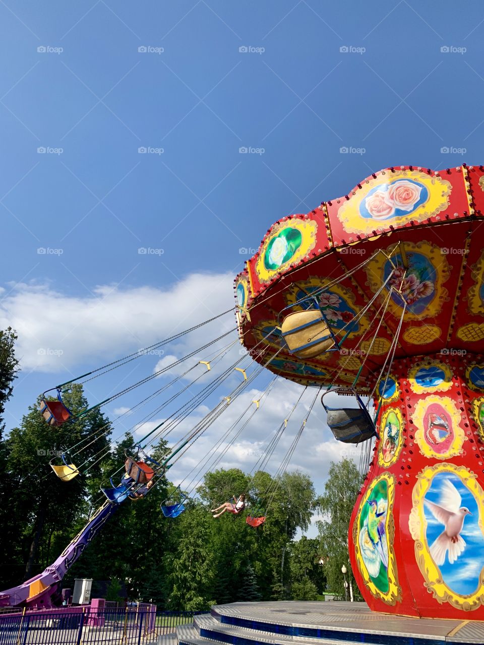 carousel in an amusement park. children ride the carousel