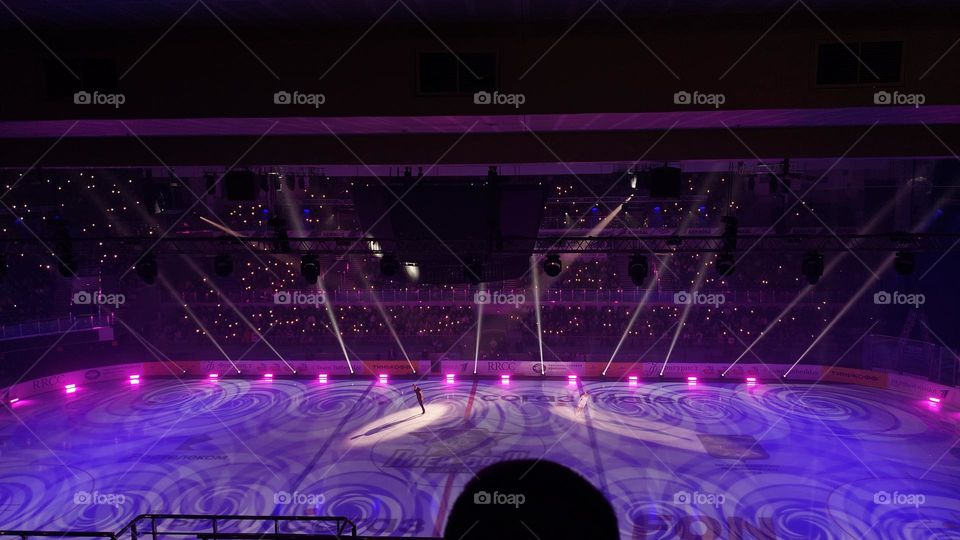 figure skating show, big stadium, lots of beautiful lights, purple light