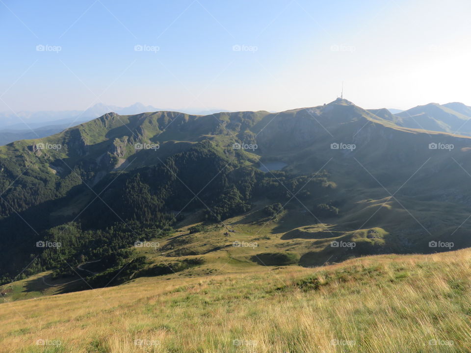 Mountain valley and lake in distant mountain range