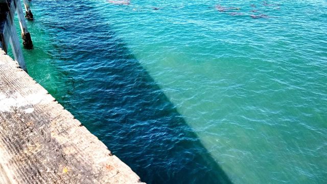 Shadow cast on the water by the Ocean Beach pier (San Diego, CA)