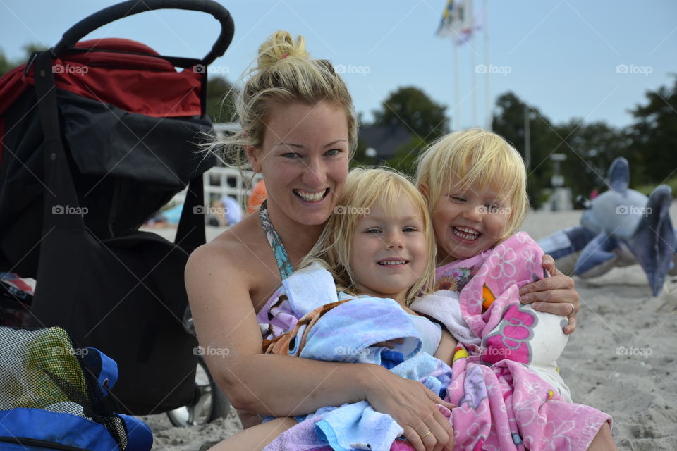 Mother with her doughters at the beach Ribban in Malmö Sweden.