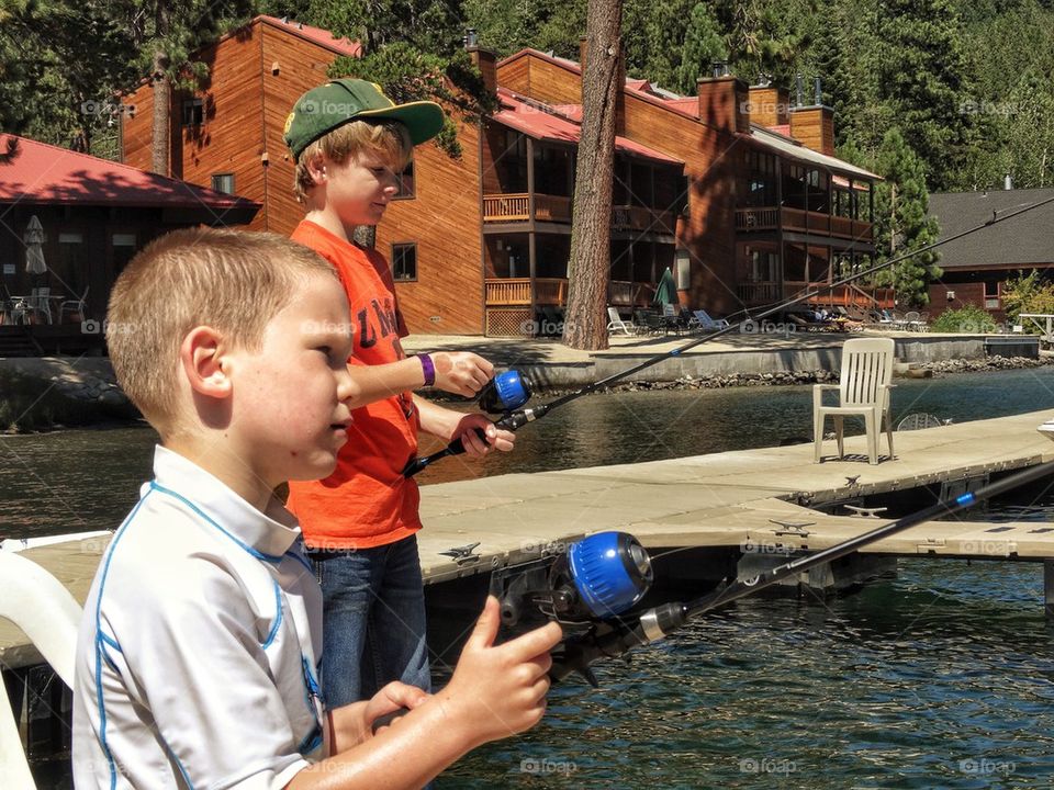 Young Brothers Fishing In A Lake
