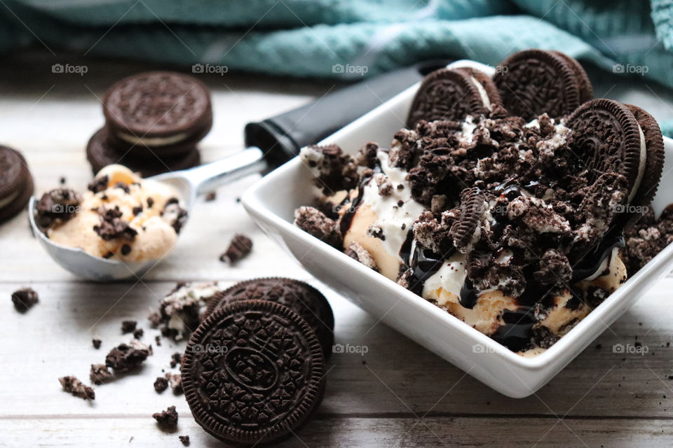 Delicious vanilla ice cream with cookies and chocolate sauce