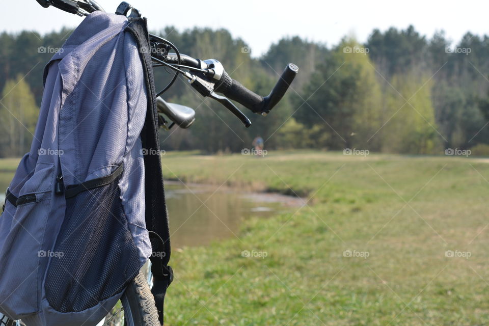 bike and backpack on nature landscape, social distance