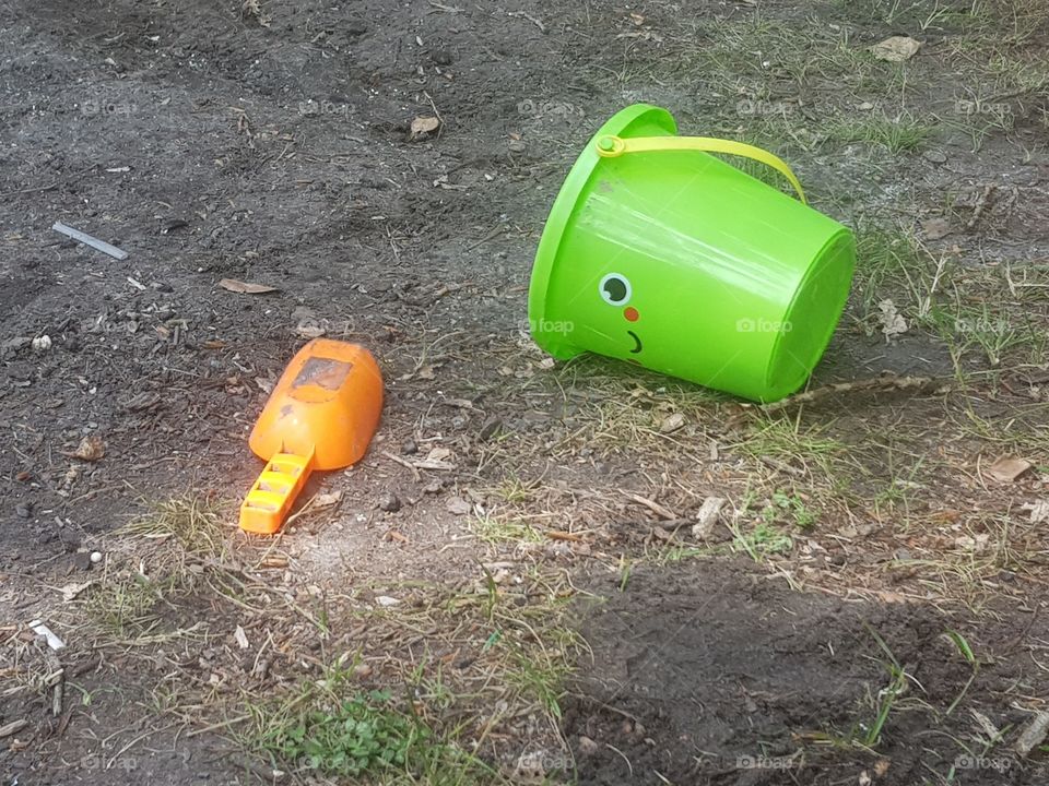 Plastic toy bucket and plastic toy scoop, to play with in the sand. For children.