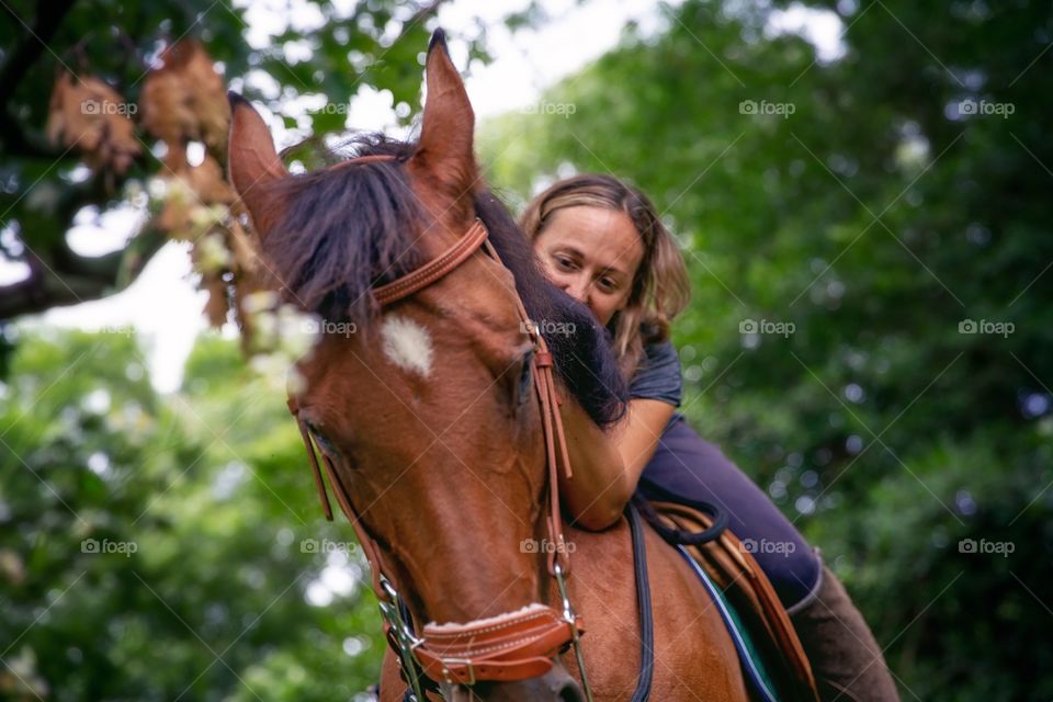 A girl and her horse. Summer riding in the forest. 