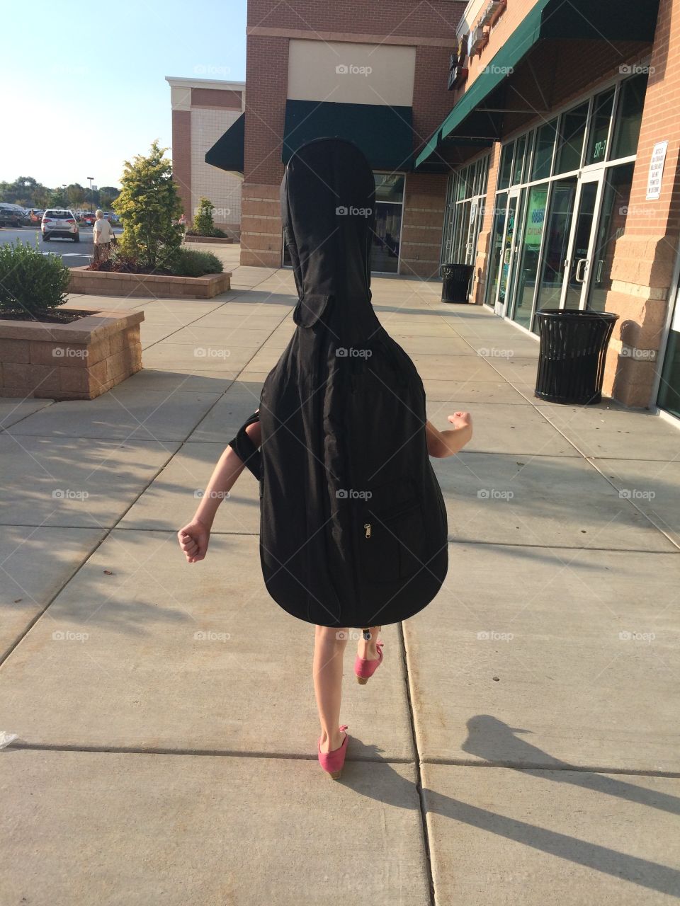 Walking Cello. My daughter's first cello is bigger than she is! We were amused by the fact that she looked like a walking cello.