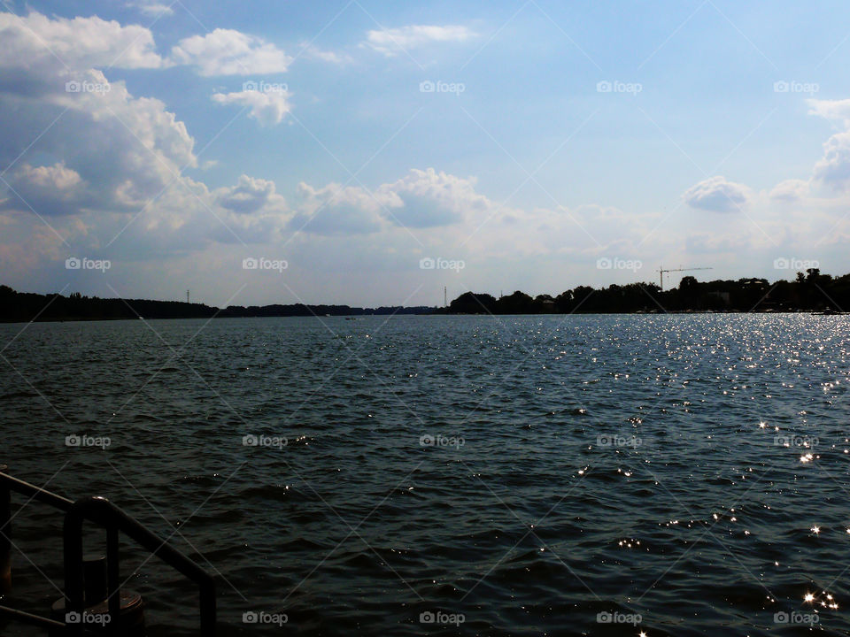 Silhouette of forest surrounding lake in Neuruppin, Germany.