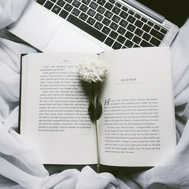 books and flowers on a bed weather