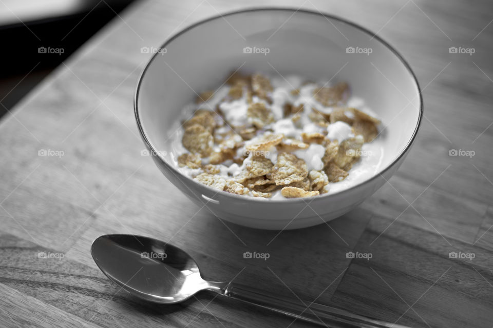 selective color on a cereal bowl with yogurt for healthy morning breakfast