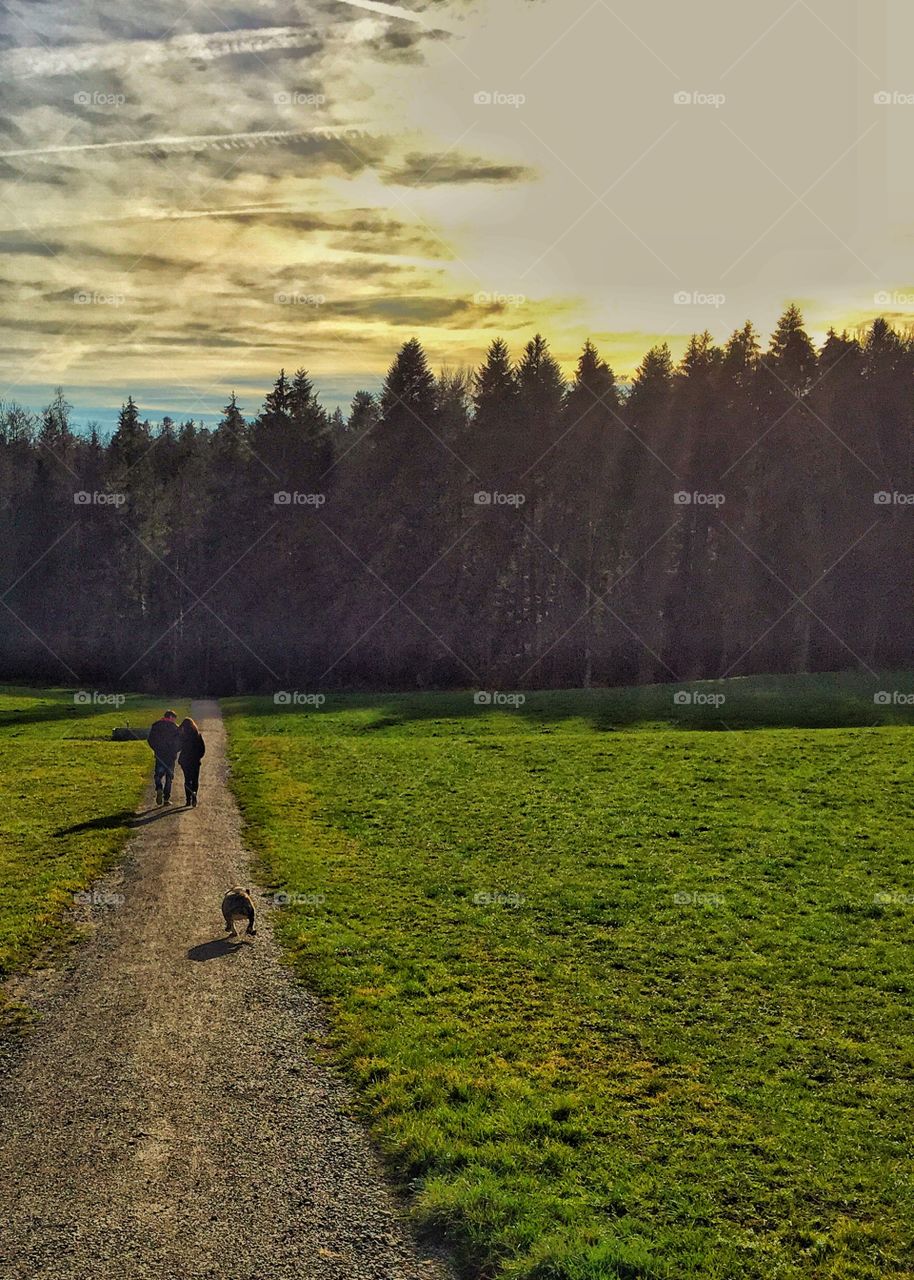 Two people walking on country road in scenery landscape