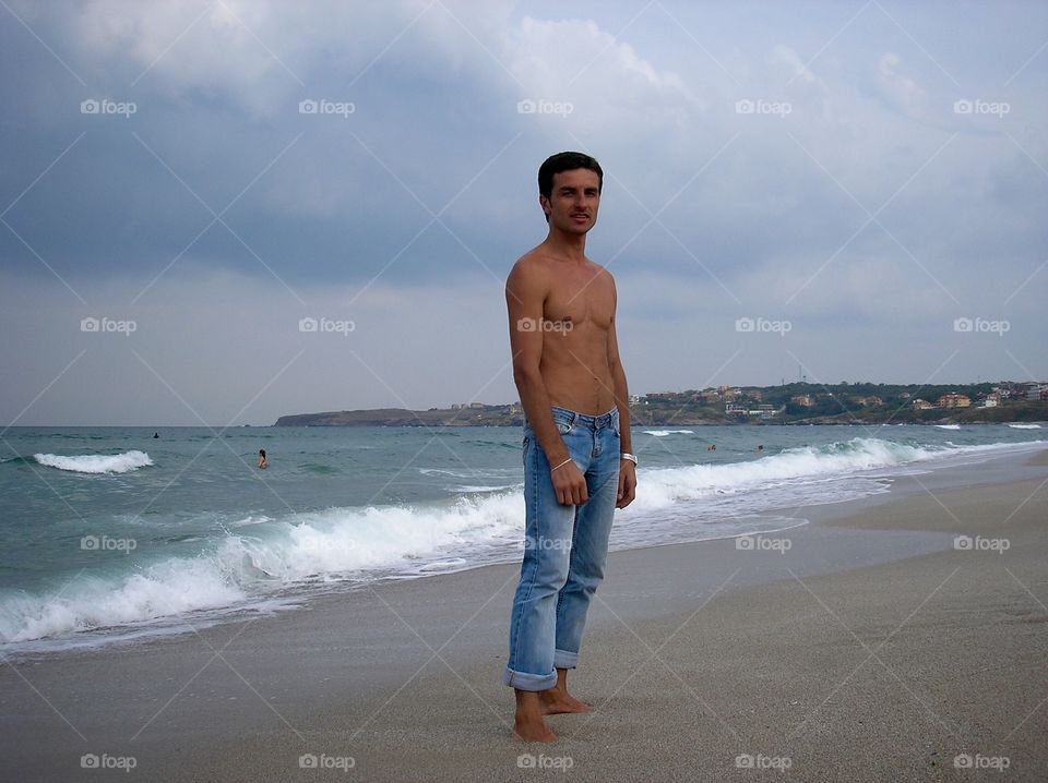 Man in jeans on the seacoast