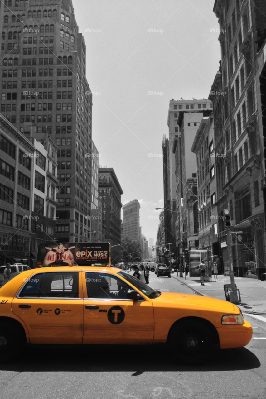 New York City yellow cab. Flatiron building in the background.. New York City yellow cab. Flatiron building in the background.
