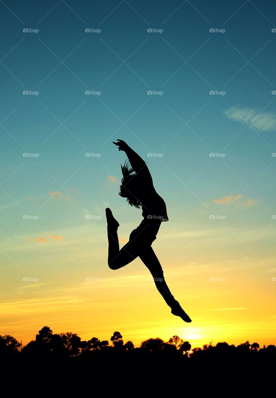 Silhouette of a girl jumping in air