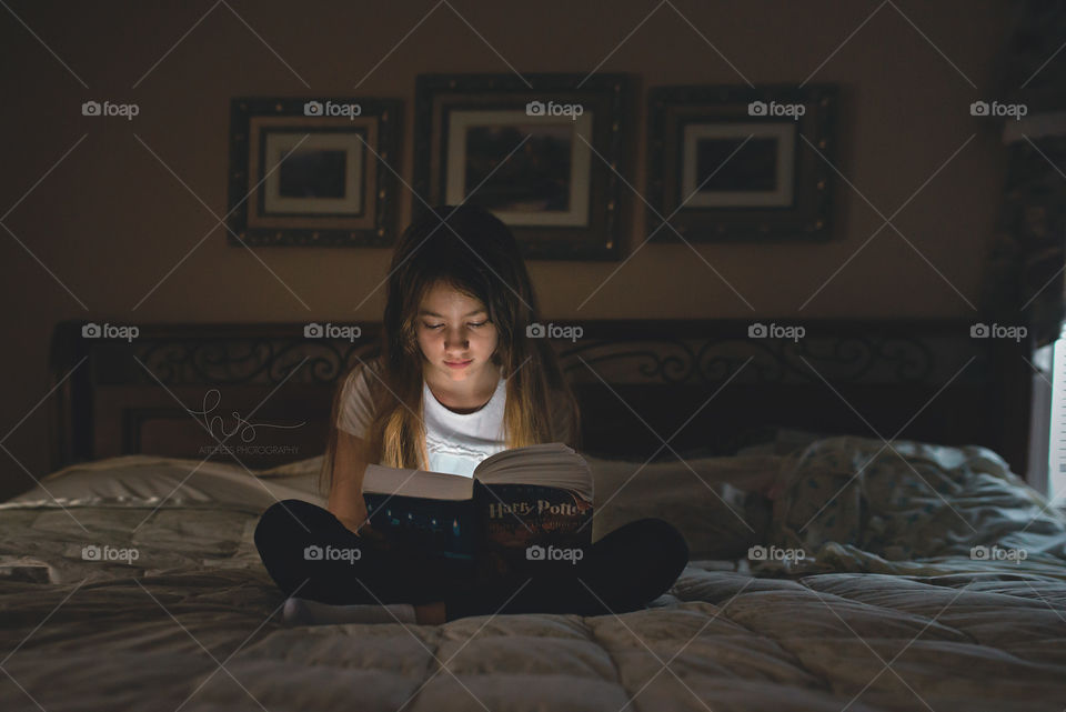 Older child reading Harry Potter
