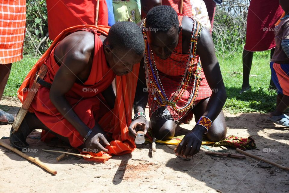 Making fire. The Maasai men demonstrating fire making.
