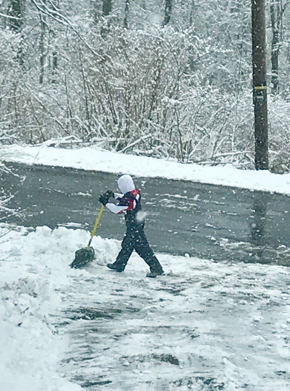 Boy shoveling snow