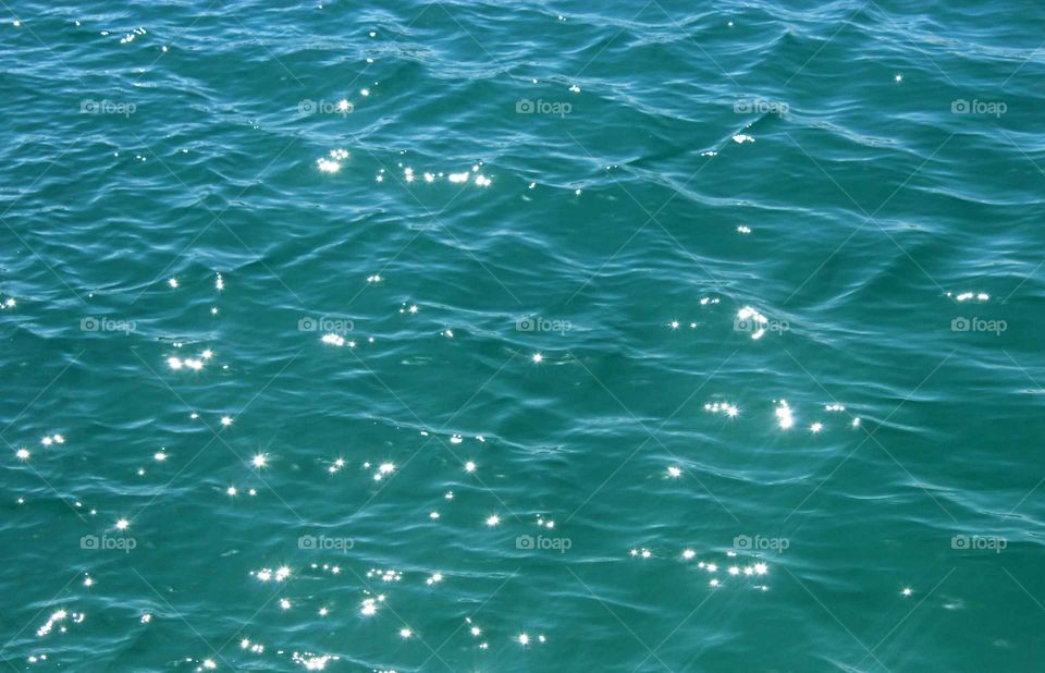azure water with sun reflections