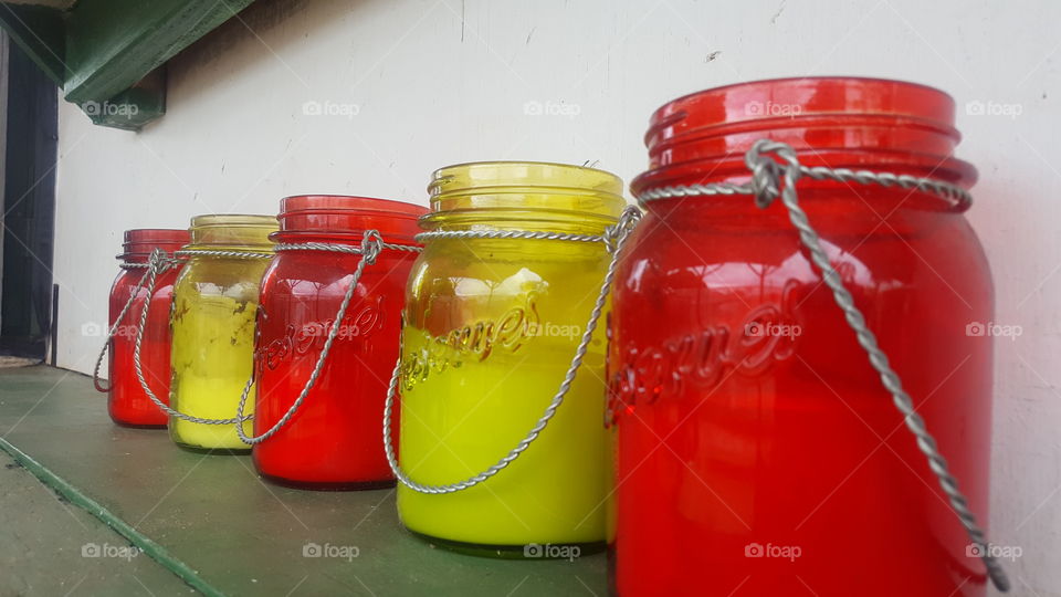 red and yellow alternating Mason jar candles.