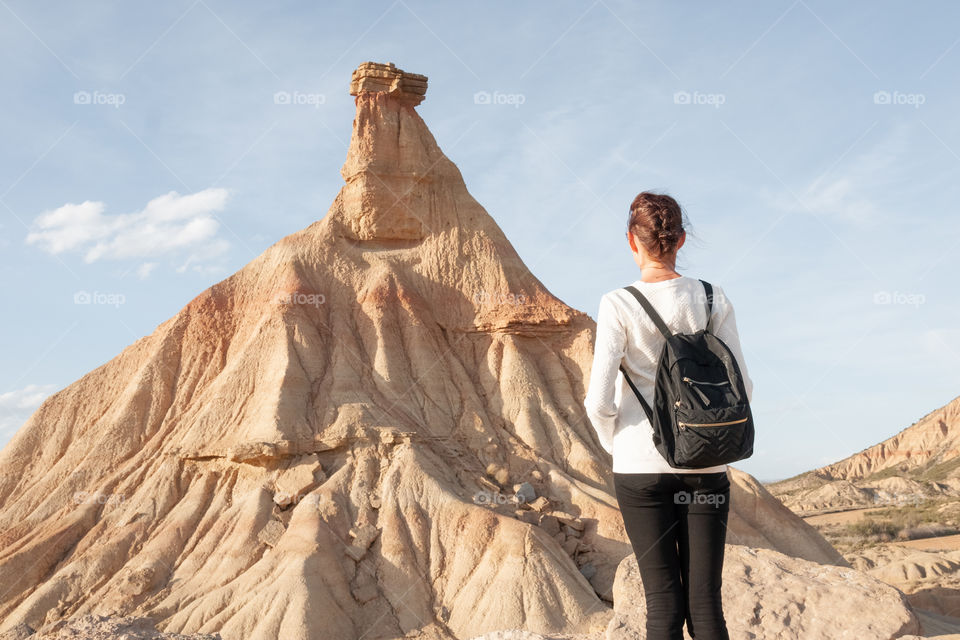 A girl looks at a natural landmark. Park Reales Bardenas in Spain 