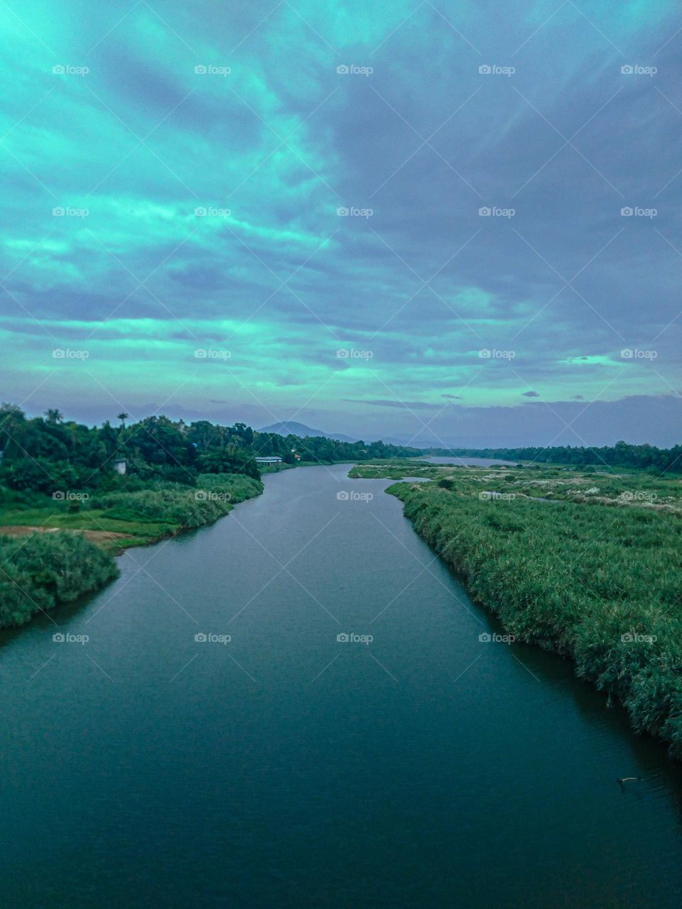 River and meadow and distant mountain range