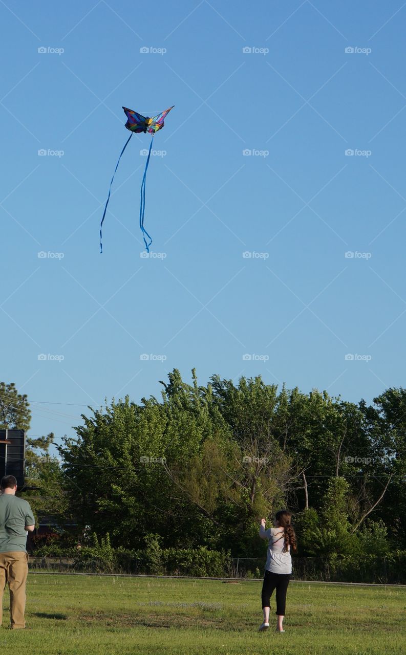 Flying a butterfly kite. Fun day with dad