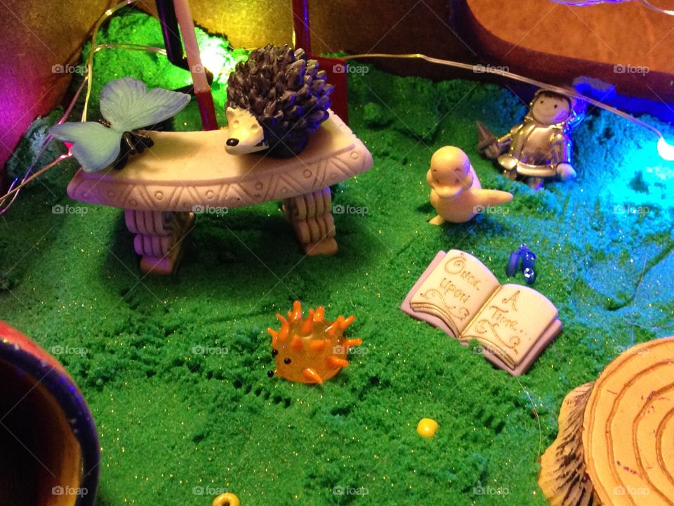 Toy critters gather for story time in the fairy garden