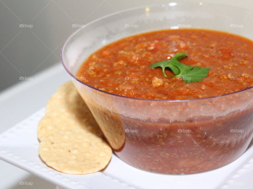 Homemade, all natural turkey chili with rice crackers and fresh parsley to accent the chili.