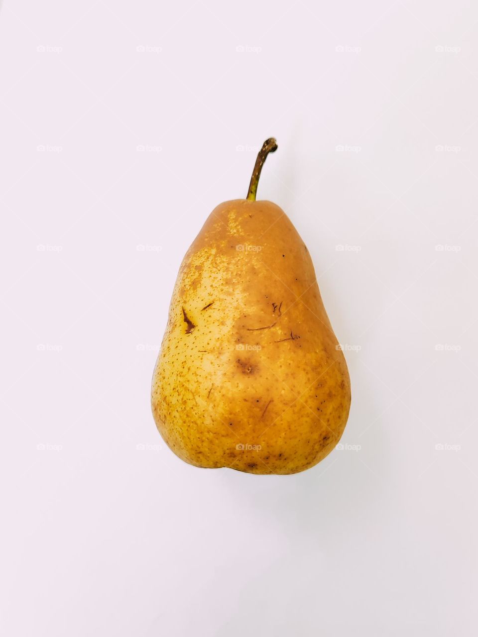 Ripe brown yellow pear fruit close up isolated side view