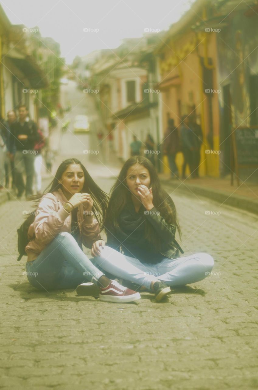 Girls sitting on a cloudy day