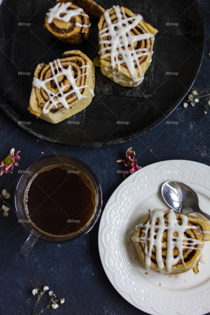 cinnamon rolls and cup of coffee on the table flat lay