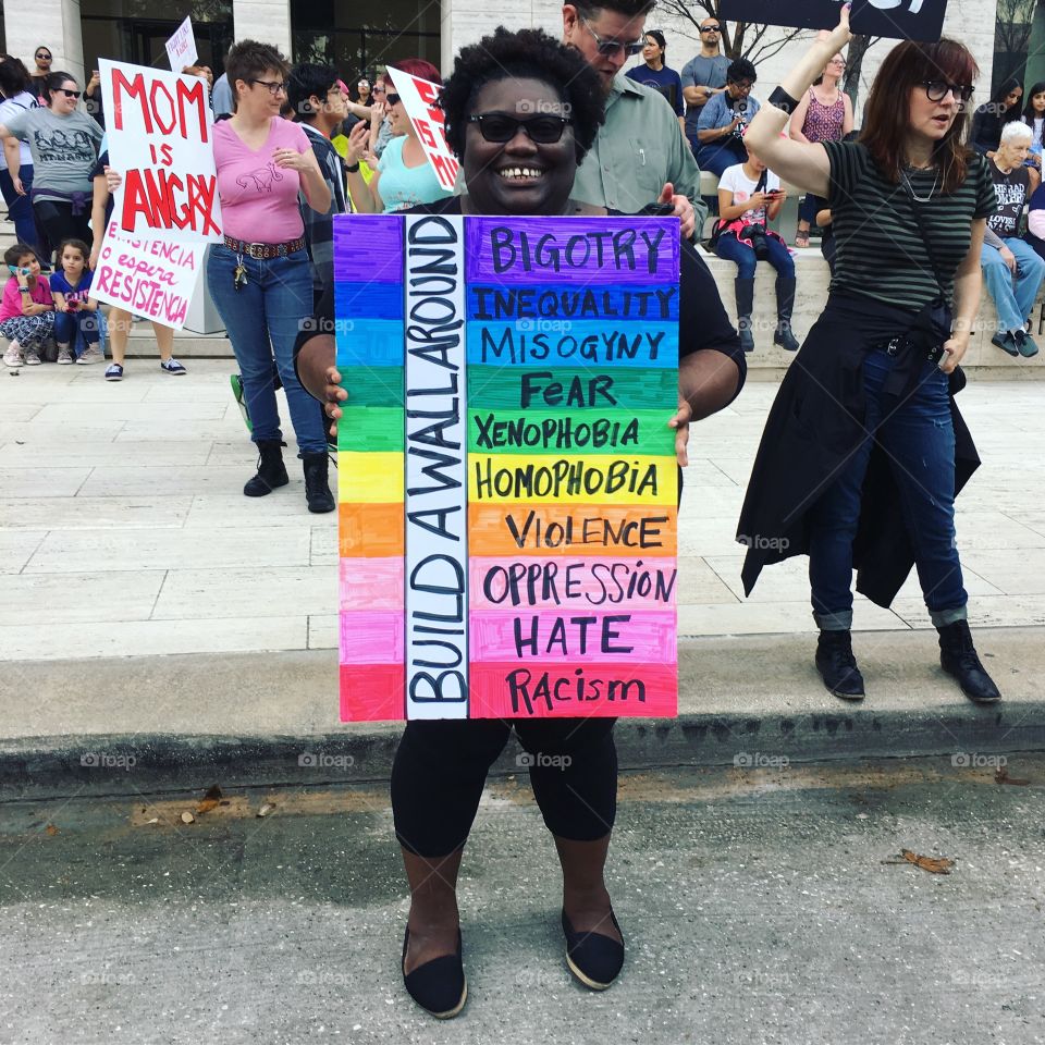 Woman holding a "Build a Wall around" rainbow sign. 
Photo taken at Woman's March Houston January, 21 2017 
