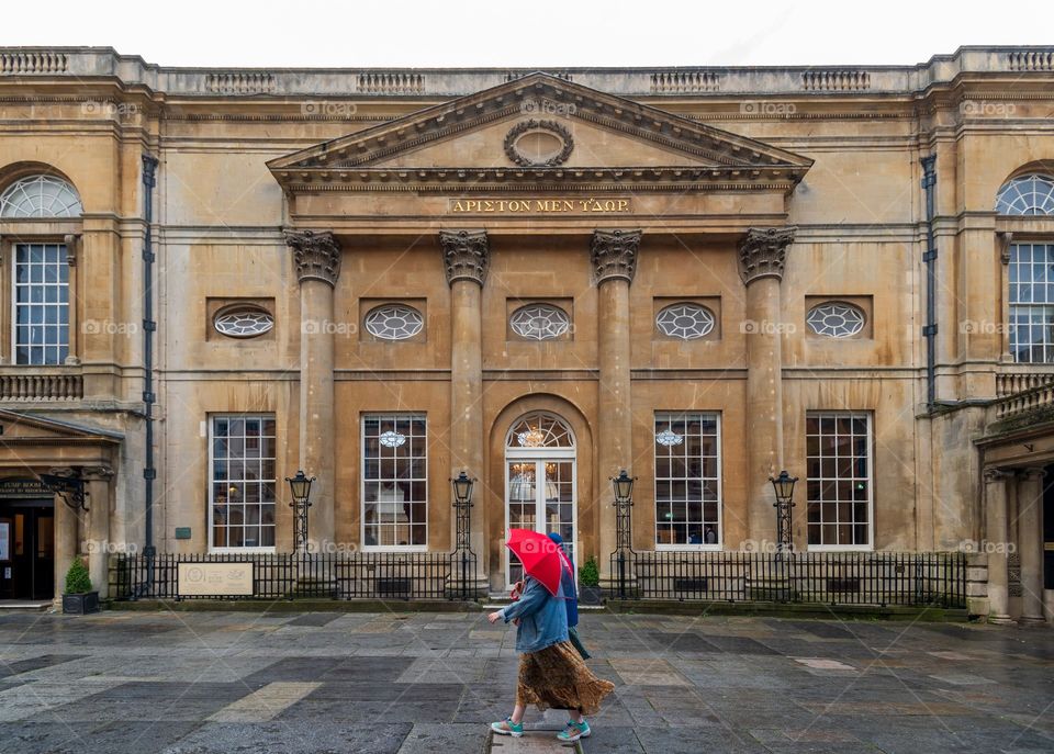 Red umbrella. Translation from old Greek: Water is  best. Roman Baths. City of Bath. UK.