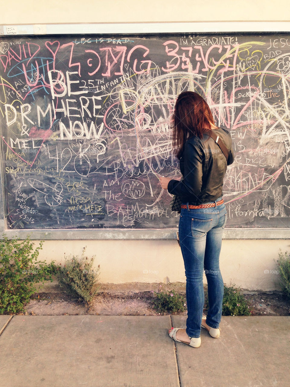 WOMAN AT CHALKBOARD