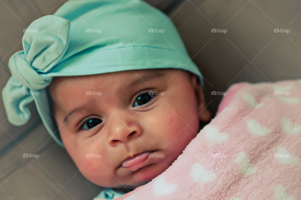 Baby with pouty sad expression, baby is sad, baby girl with sad expression, baby about to cry, colorful outfit on sad baby, newborn expresses sadness 