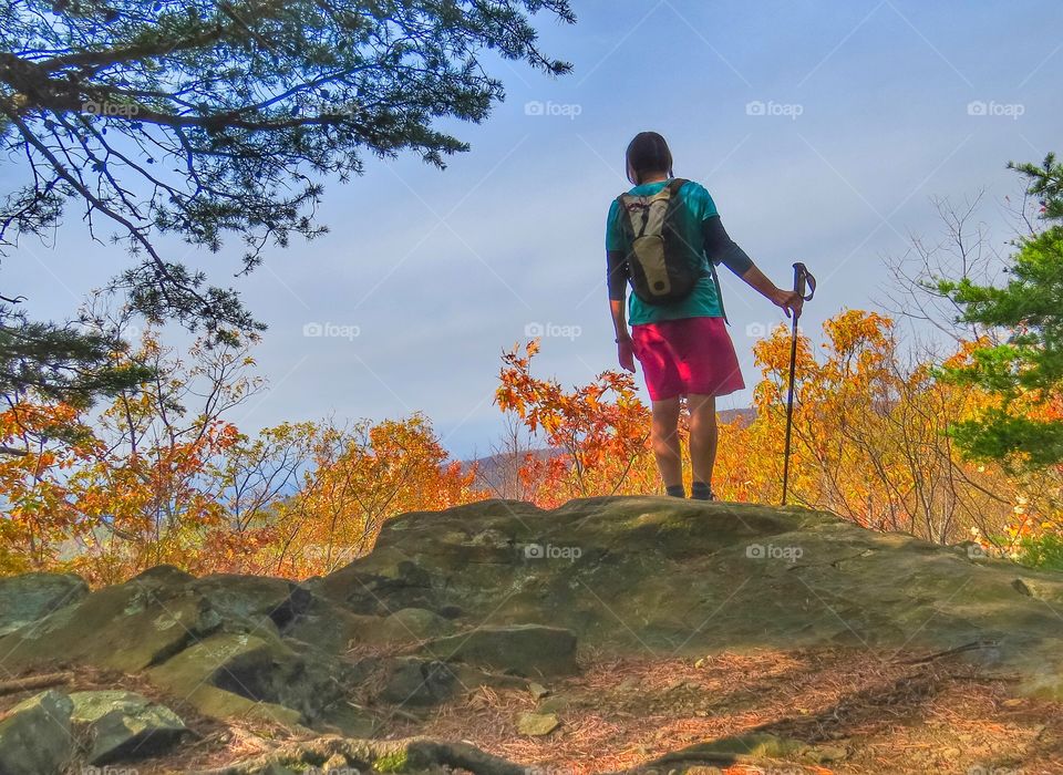 Woman hiking looking at the view.