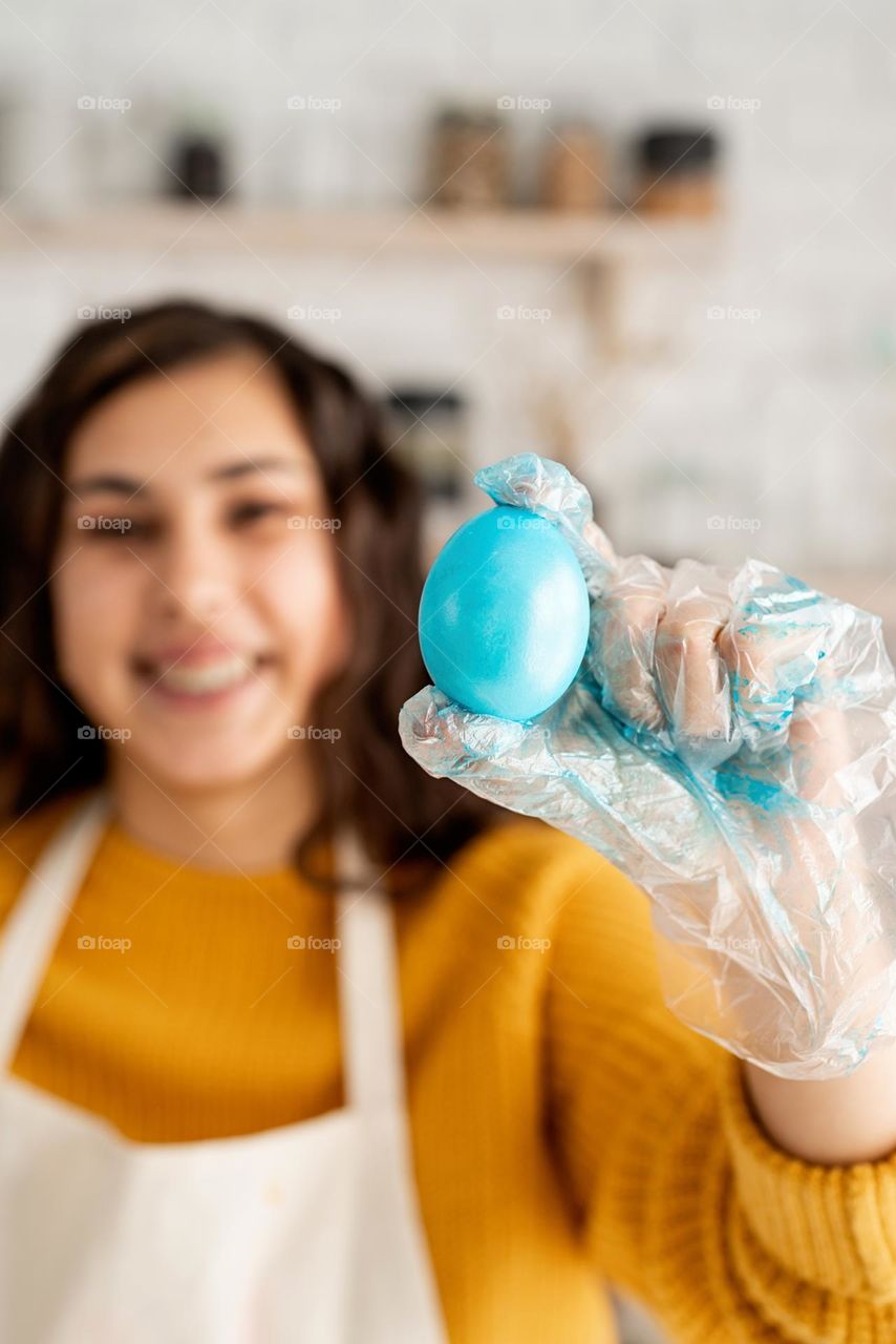 woman coloring Easter eggs