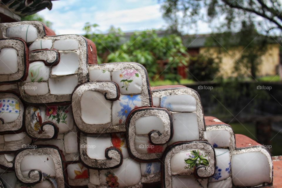 Detail of stone mosaic tiles from Vietnamese building.