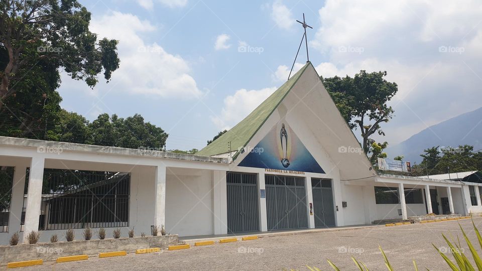 entrance to the church in the shape of a triangle with the beautiful Miraculous Virgin at the entrance