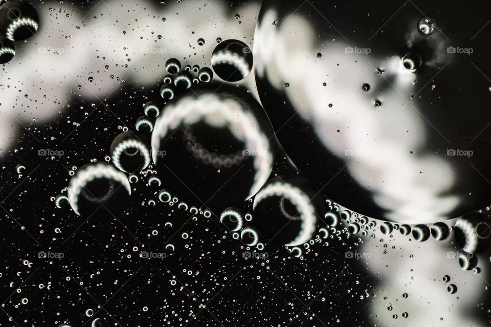 Small bubbles of vegetable oil in water close-up.