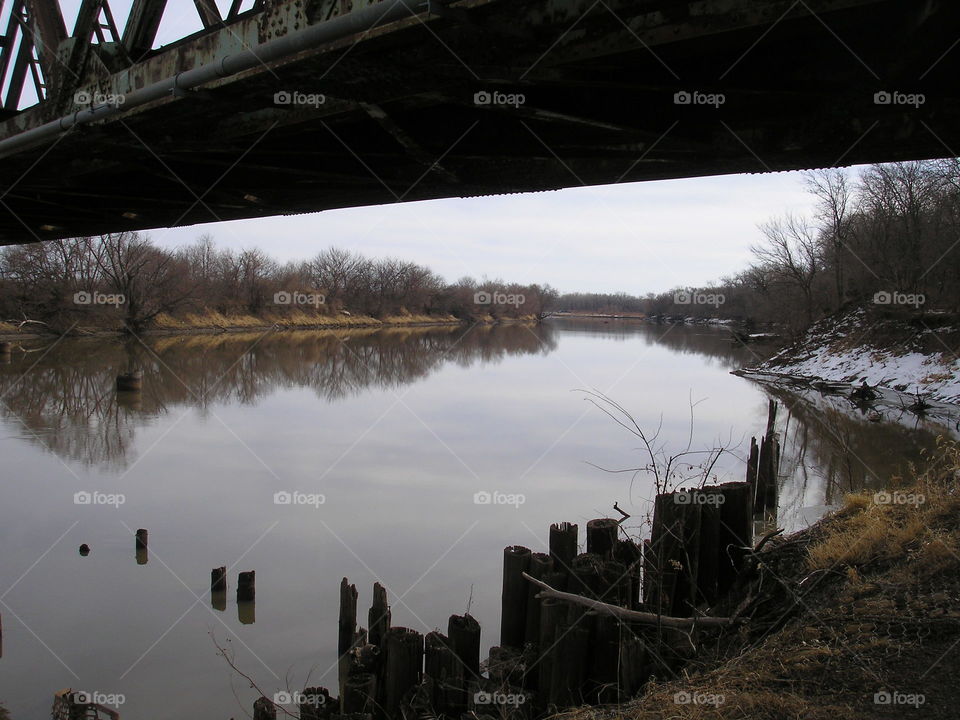 River framed by train bridge. Train bridge over river