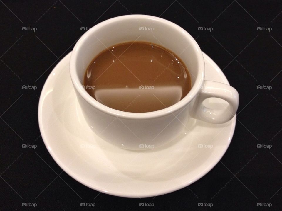 A cup of coffee in black background