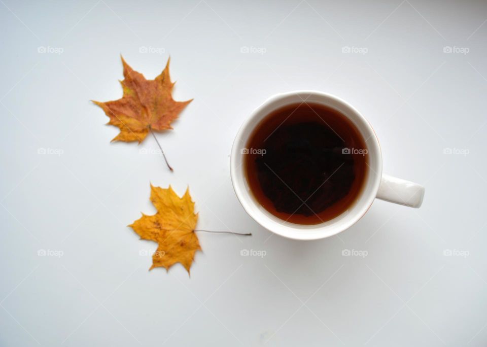 cup of coffee with two autumn leaves, autumn relax, lifestyle