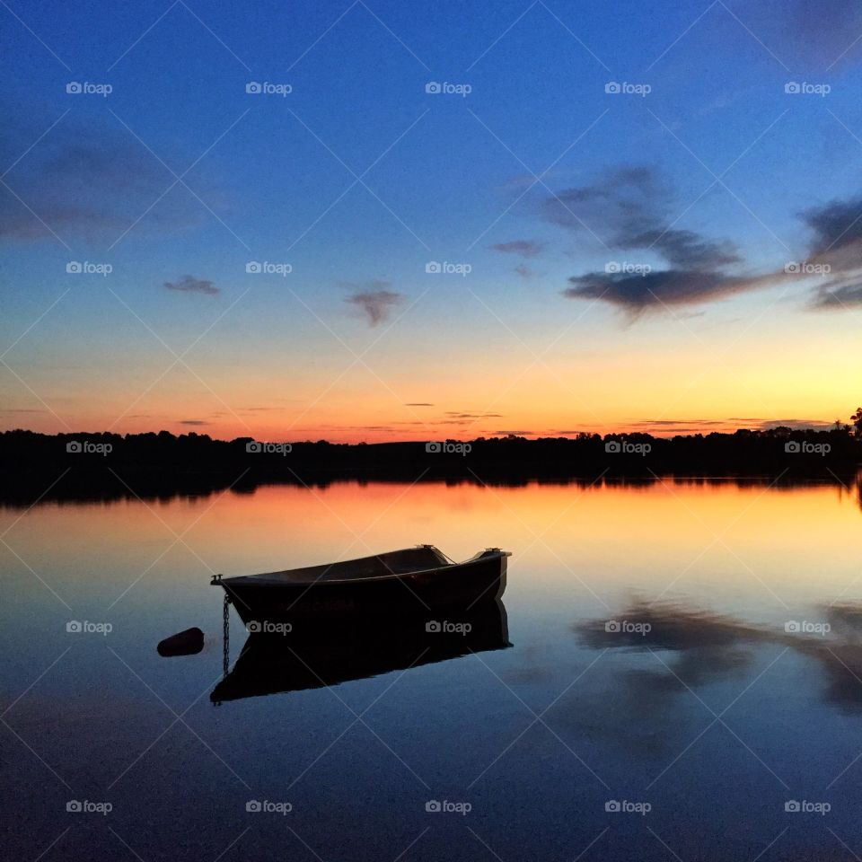 Lake at sunset with row boat
