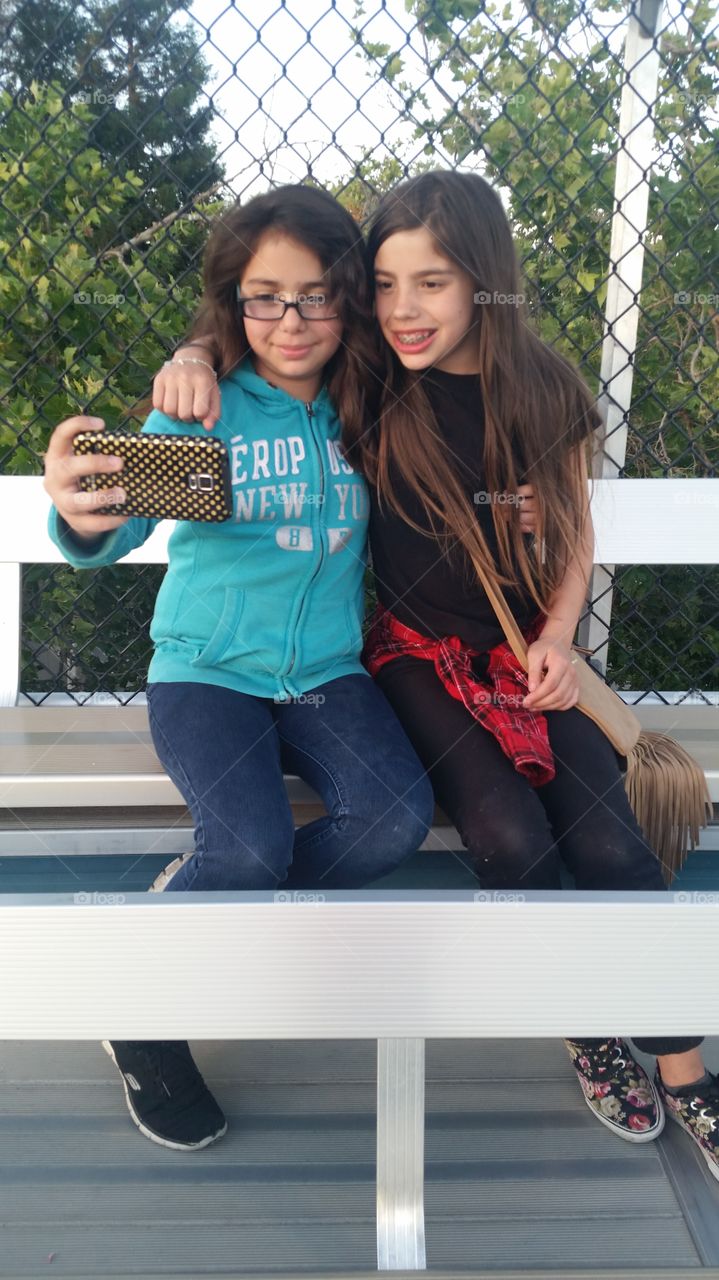 Two friends taking selfie with mobile phone