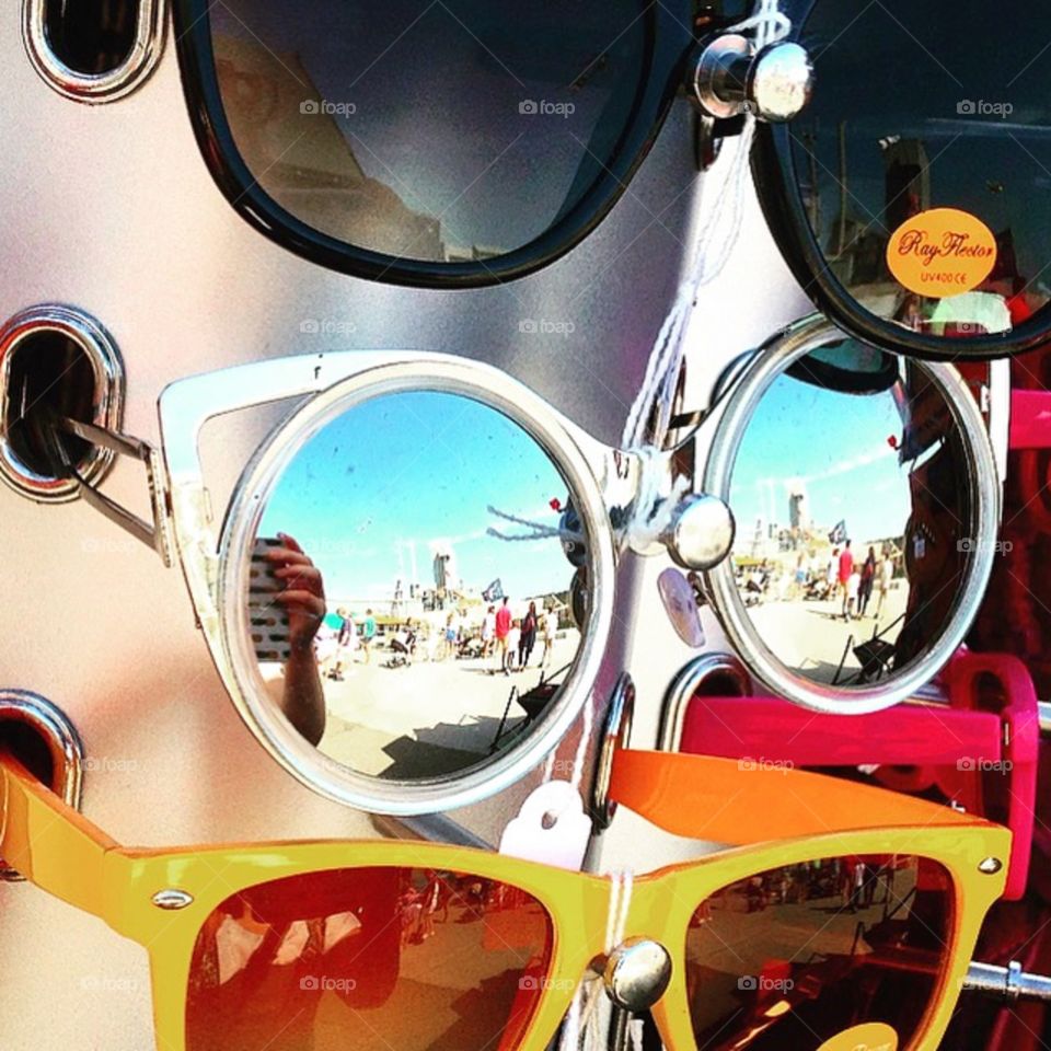 Brightly coloured sunglasses for sale at the seaside 
