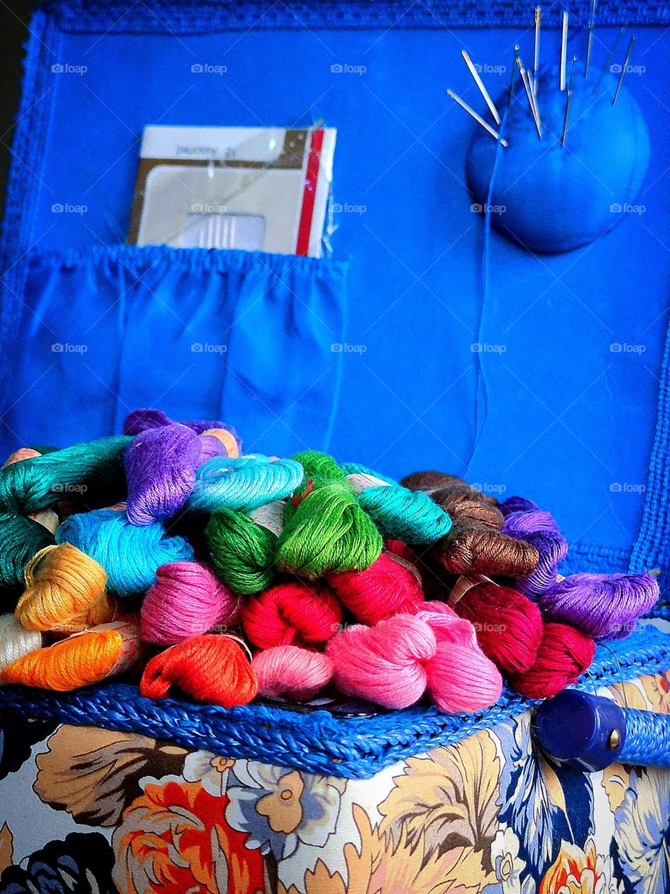 Multicolored embroidery threads in a sewing box
