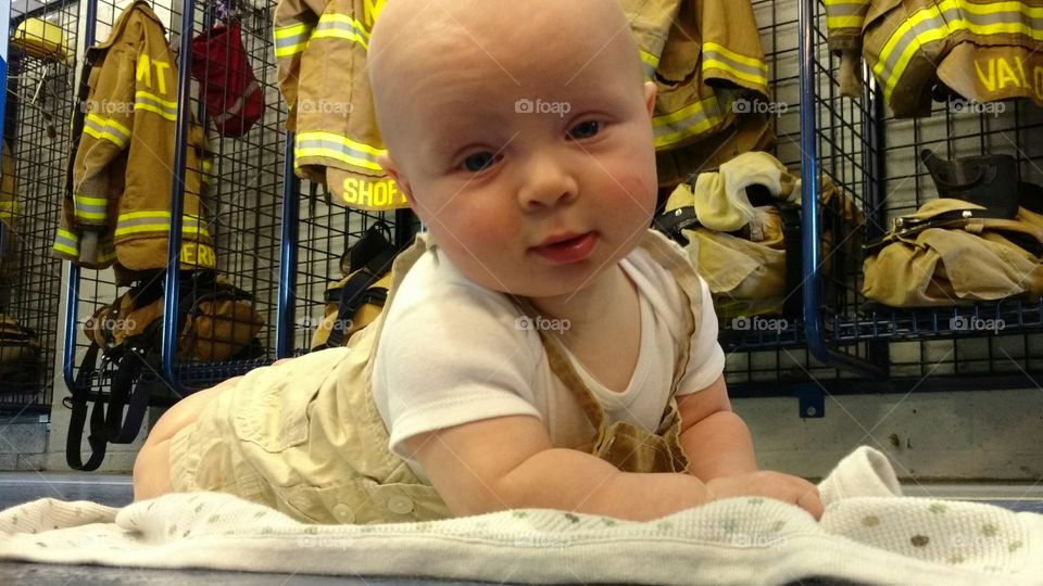 baby at the firehouse learning to be a fireman