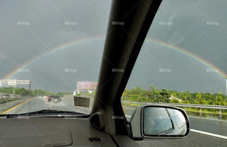 rainbow  through the car
half blurred half clear exactly divided into two portions