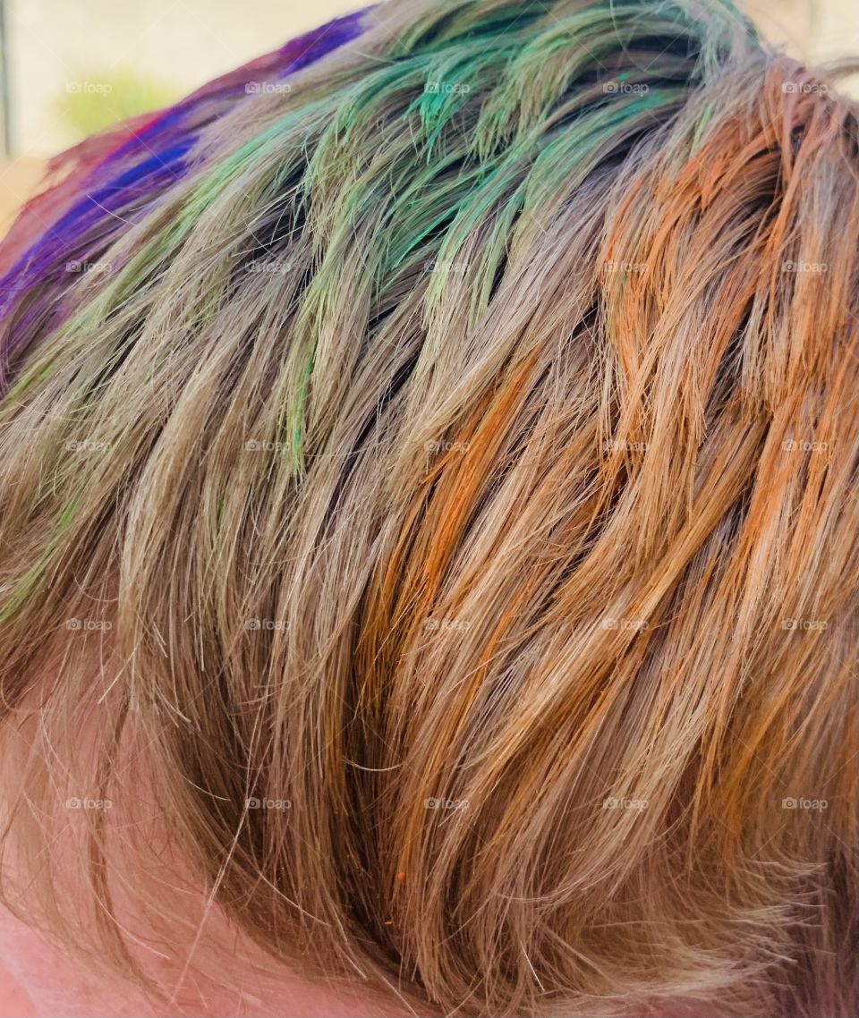 Child with painted rainbow color hair 